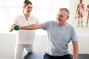 Physical therapist working with an elderly patient.