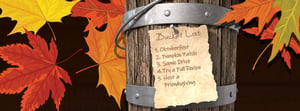 bucket with a list pinned to it and fall leaves 