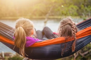 friends sitting on hammock