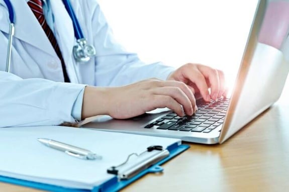 healthcare worker typing on computer