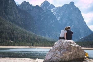 couple sitting on rock