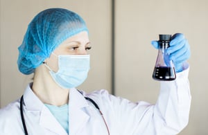 laboratory professional holding beaker