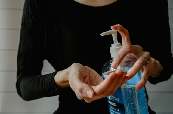 squirting hand sanitizer into hands
