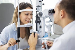 Ophthalmic Assistant using eye machine on patient