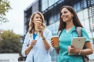 nurses drinking coffee outside