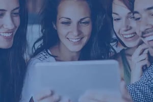 group of young friends reading articel on an iPad