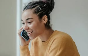 student talking on the phone with a Student Outreach expert