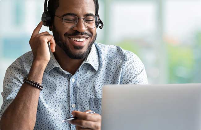 a Recruiter with a headset at a computer 